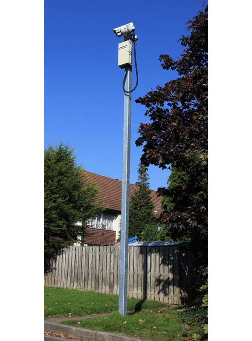 Galvanised steel CCTV column with camera and control box installed in residential area, ideal for surveillance and security monitoring.
