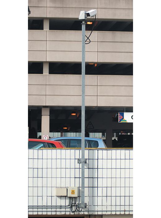 Wall-mounted CCTV pole with camera, ideal for surveillance in urban or car park settings. Secure, space-efficient design for reliable security coverage.